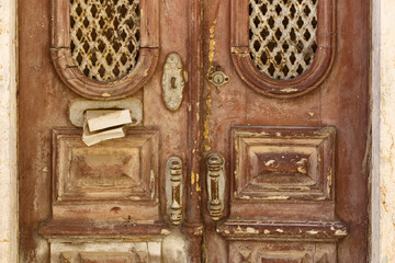 old wooden door with handle in the old town of Tavira, Algarve, Portugal
