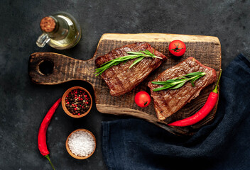 Grilled beef steak with spices on a stone background