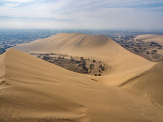 Fototapeta na wymiar Desert sand dunes of Ica, Peru near Huacachina at a hot, sunny day 