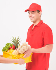 Portrait of a man in red uniform is holding fresh food in plastic box on white background,  home delivery concept