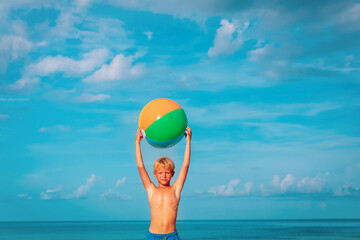 happy boy play with ball on beach vacation