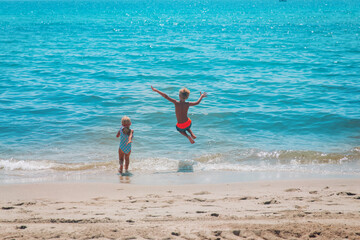 Fototapeta na wymiar happy boy and girl run swim on beach
