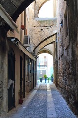 Fototapeta na wymiar evocative image of an ancient street in the historic center of Palermo in Italy