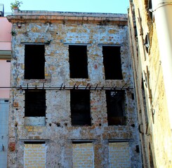 evocative image of the facade of an ancient uninhabited building in the historic 
center of Palermo in Italy