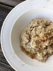 Oatmeal with honey and cinnamon on the table