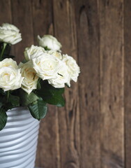 Floral card. Beautiful white rose on a wooden background.