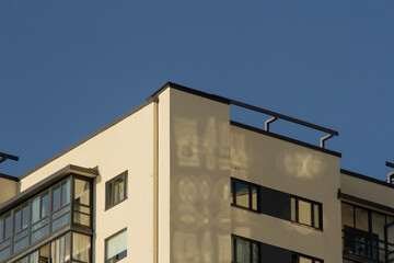 Sun glare on the wall of a house near the roof