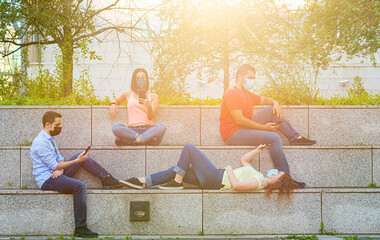 the new way to socialize millennials in the city using protective masks, a group of young people...