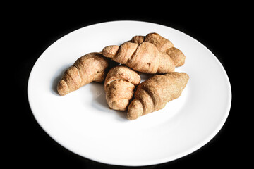 Croissants on a white plate. Fresh bakery