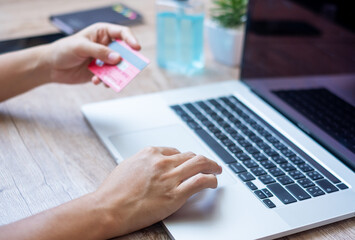 woman holding credit card and using laptop for online shopping while making order at home office. business, lifestyle, technology, ecommerce, digital banking and online payment concept
