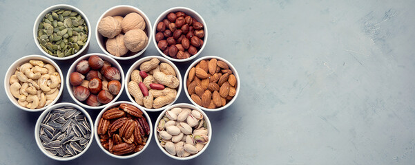 Obraz na płótnie Canvas Different types of Nuts in ecofriendly cups