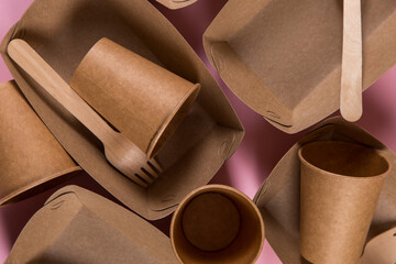 Paper eco-friendly utensils, without contamination, for reprocessing, brown on a pink background.