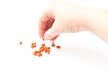 Coenzyme q10 supplement capsules in hand close-up on  white background