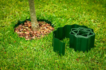 green plastic lawn edge tape for flowerbed and tree edging