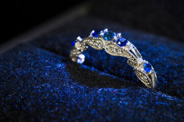 Engagement ring with blue stones and sapphires in the velvet part.