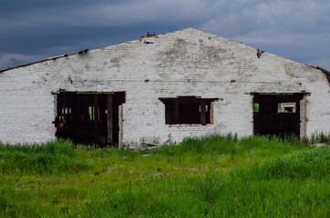 The old ruined abandoned barn for cows. Destroyed agriculture