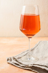 a tall, clear glass of rich orange wine. Alcoholic beverage