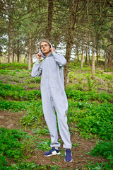Handsome, young guy in a tracksuit plays sports in the park on the nature. Healthy lifestyle.