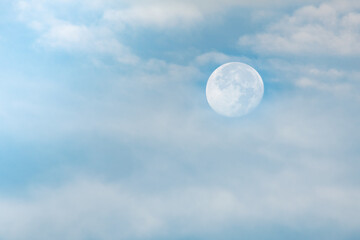 Full moon in the morning with blue sky and a little cloudy. Two