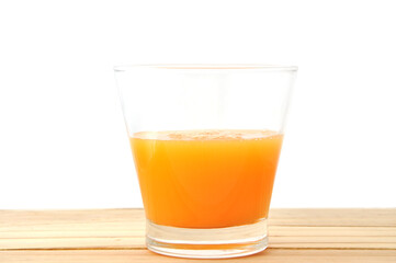 glass of orange juice on wood table