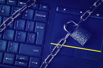 Black keyword and metal chain with lock. The concept of blocking or ban electronic money,...