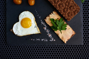 fried eggs with bread on a black background