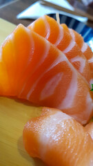 Salmon sashimi on sushi platter.