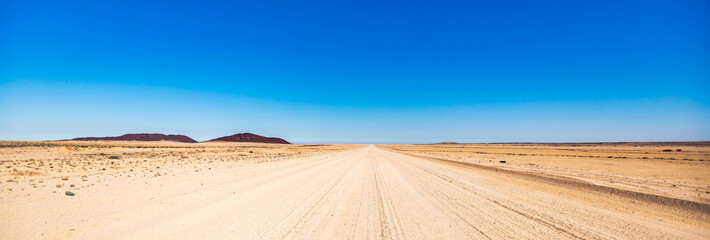A gravel road in Namibia - obrazy, fototapety, plakaty