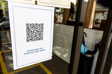 OR code Contactless menu displayed on restaurant door with new normal. Code is edited and not valid