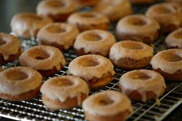 Maple donuts cooling on a rack