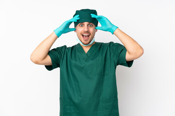 Surgeon in green uniform isolated on isolated white background with surprise expression