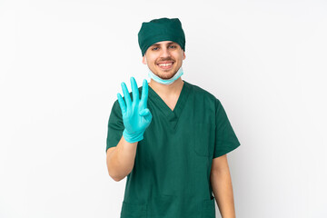 Surgeon in green uniform isolated on isolated white background happy and counting four with fingers