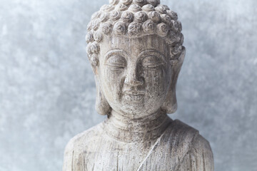 Meditating Buddha Statue on bright background.