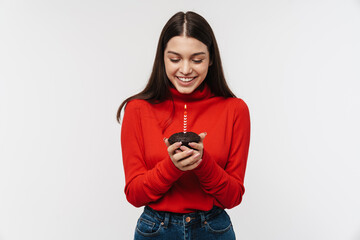Photo of happy caucasian woman smiling and holding cake with candle