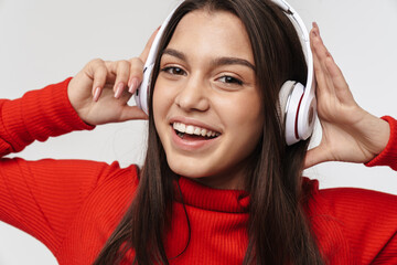 Photo of happy caucasian woman smiling while using headphones