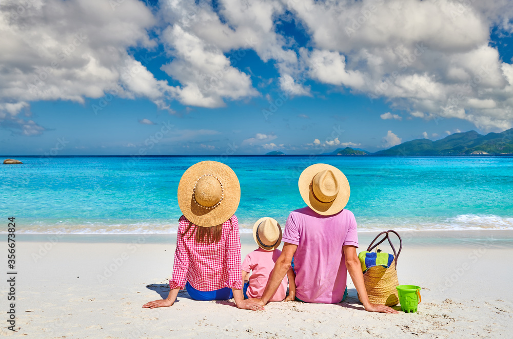 Wall mural family with three year old boy on beach. seychelles, mahe.