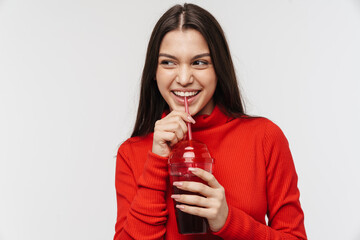 Photo of cheerful woman smiling and drinking soda from plastic glass
