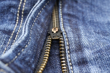 Macro close up of isolated blue casual denim jeans pants with metal teeth zipper