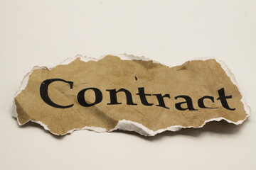 Cancelled agreement concept: Close up of isolated crumpled piece of scrap paper with word contract,...