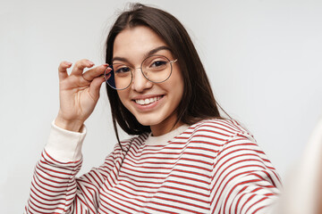 Photo of happy brunette young woman wearing eyeglasses smiling