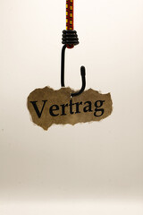 Luring customers and unfair adhesion contract concept: isolated piece of brown old scrap paper...