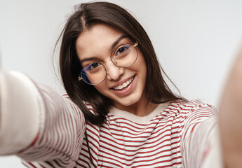 Photo of happy brunette young woman wearing eyeglasses smiling