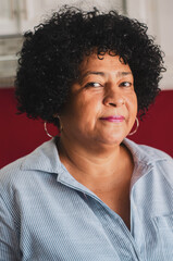 portrait dominican adult woman with dark skin with curly hair with white background for enrollment