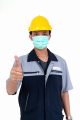 Male worker wearing a helmet and face mask and looking at camera in studio on isolated white background. Concept of protection from coronavirus (COVID-19).