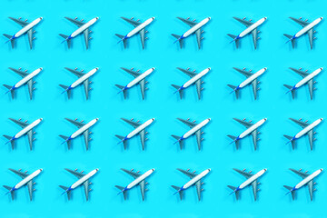 Fototapeta premium Pattern made of model airplane on blue background.