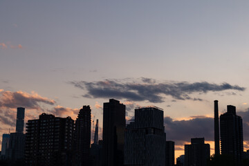 Fototapeta na wymiar Manhattan and Roosevelt Island Skyline Silhouette during Sunset in New York City 