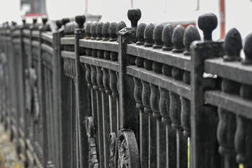 A fragment of a cast-iron fence in perspective