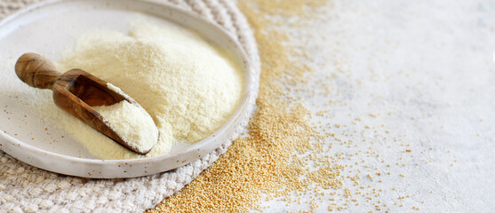 Plate of raw Amaranth flour with a spoon and Amaranth seeds