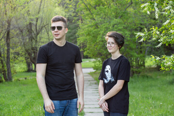 A guy and a girl walk and chat in the park.