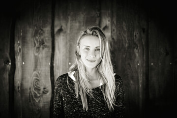 Young woman in front of wooden wall